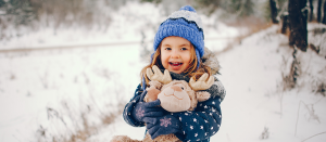 little-girl-blue-hat-playing-winter-forest-site.png
